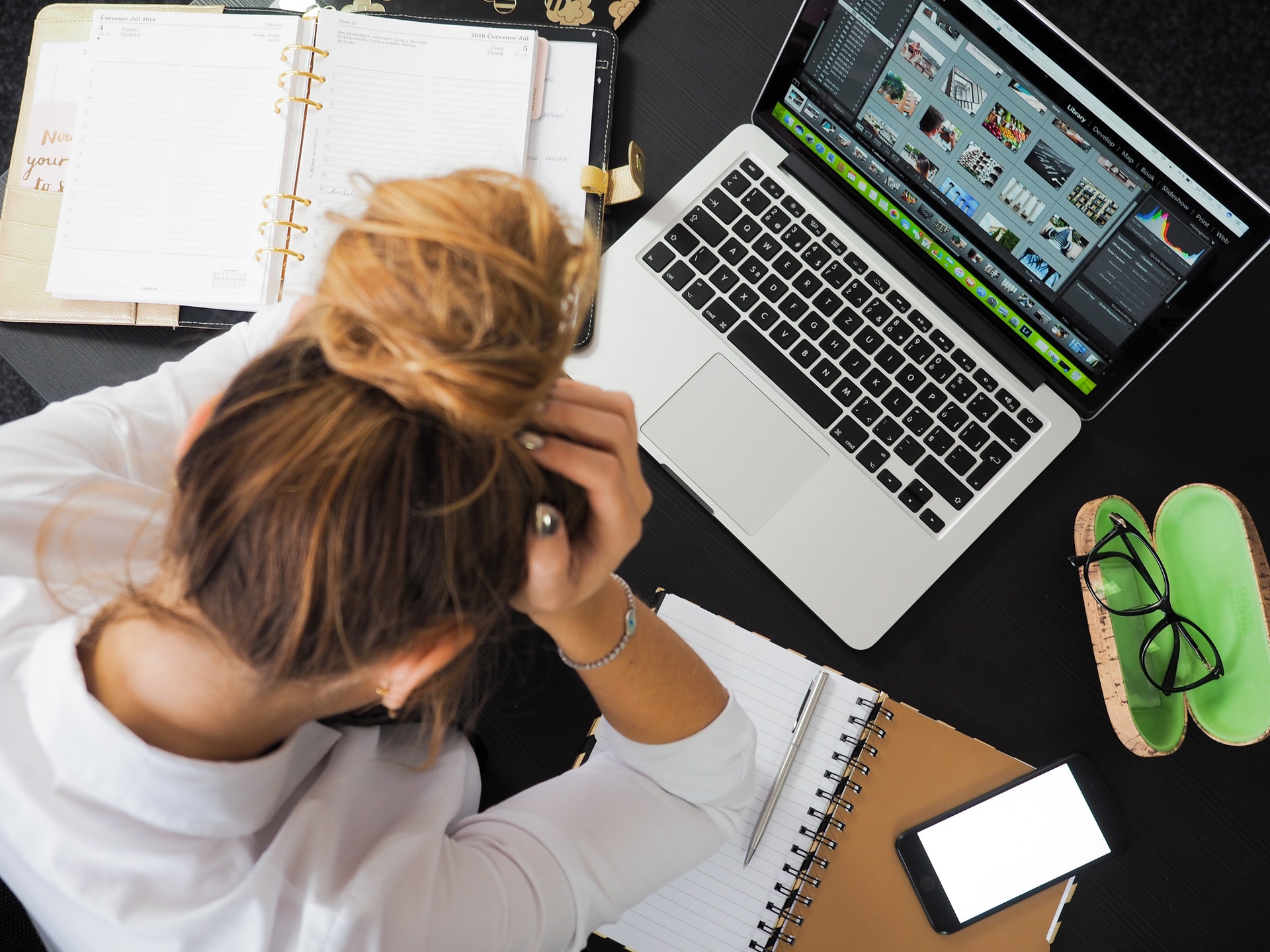 Woman holding her head in her hands from stress.