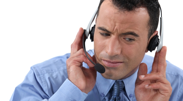 Man listening on phone headset.